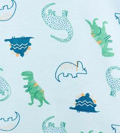 a blue and green t - shirt with dinosaurs on it