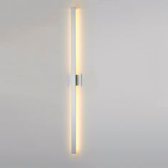 a white wall light with two lights on it's side and one is lit up