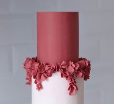 a white and pink cake with flowers on it