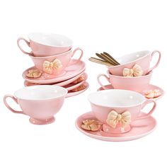 pink tea cups and saucers with bows on them