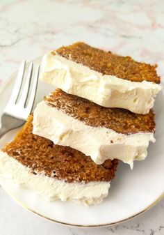 three pieces of cake sitting on top of a white plate next to a knife and fork