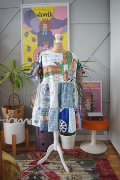 a mannequin is dressed in colorful clothing and has a poster on the wall behind it