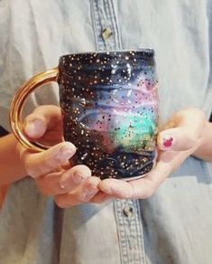 a person holding a coffee mug in their hands with stars all over it and on the inside