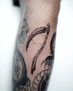 a man's arm with an arrow tattoo on it