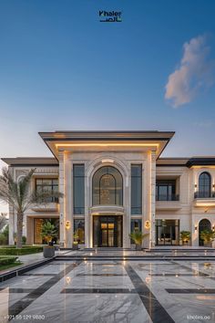 a large white building with lots of windows on it's sides and an entry way leading to the front door