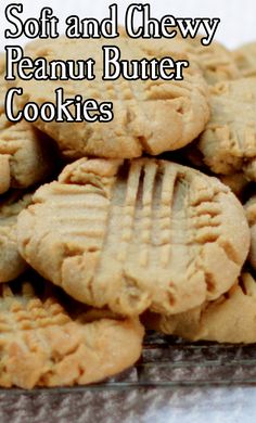 a pile of peanut butter cookies sitting on top of a table with the words soft and chewy peanut butter cookies