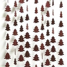 paper cut christmas trees hanging from strings