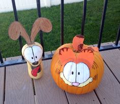 two pumpkins decorated to look like characters from the simpsons are sitting on a deck