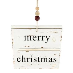 a white wooden sign with merry christmas written on it hanging from a rope and attached to a string