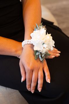 a close up of a person wearing a bracelet with flowers on it's wrist