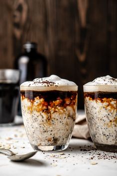 two cups filled with oatmeal sitting on top of a table