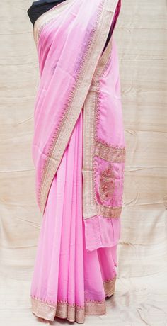 Category: Georgette Saree An exclusive Banarasi saree from Khinkhwab. Add a dash of your favorite color to your ethnic look with this beautiful Banarasi saree. Fabric - Pure Georgette Silk Georgette is a lightweight, crinkled and sheer fabric, displaying an overall bouncy look. A strong absorbent, Georgette is easy to dye and has a dull-rough texture. Georgette is made from twisting yarns of silk. Color -Pink Weave - Kadwa Craftsmanship - Ari zardozi work material used: Dabka(Saadi),sequins, res Eid Puja Pre-draped Saree With Embroidered Border, Pink Georgette Pre-draped Saree With Embroidered Border, Semi-stitched Pre-draped Saree With Zari Weaving For Navratri, Designer Georgette Pre-draped Saree With Zari Weaving, Semi-stitched Bollywood Blouse Piece With Embroidered Border, Dola Silk Pre-draped Saree With Embroidered Border For Puja, Transitional Festive Pre-draped Saree With Embroidered Border, Bollywood Style Semi-stitched Embroidered Fabric With Zari Weaving, Embroidered Art Silk Pre-draped Saree