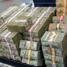 stacks of money are stacked on top of each other in a grocery store display case