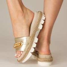 The Bardot summer sandal will be your everyday choice for every occasion. It features a exquisite fabric upper with a delicate gold chain . The white lite lug bottom is wrapped with natural jute trim resting on a elevated footbed wedge. The luxurious design is further enhanced by the soft kid sued wrapped foot. Whether running errands , attending casual gatherings, or simply enjoying a leisurely day out, the Bardot provides the perfect blend of style and comfort. Made in Italy leather Delicate Gold Chain, Luxurious Design, Wedge Sneakers, Pumps Flat, Sandals For Sale, Natural Jute, Flat Sneakers, Boots For Sale, Metallic Leather