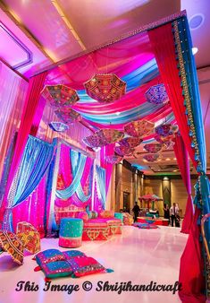 an elaborately decorated room with pink and blue drapes