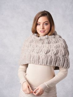 a pregnant woman wearing a knitted scarf