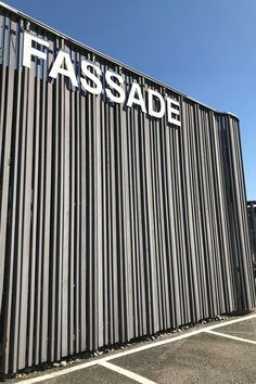 a black and white striped building with the word fassade on it's side