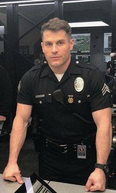 a police officer standing in front of a laptop