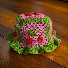 This handmade crochet bucket hat features vibrant pink and green yarn with charming cherry motifs. It's a unique, stylish accessory perfect for adding a playful touch to any outfit. Playful Handmade Bucket Hat For Spring, Playful Crochet Bucket Hat For Spring, Pink Hand Knitted Crochet Hat For Summer, Cute Pink Crochet Knitted Hat, Cute Handmade Crochet Hat For Spring, Hand Knitted Pink Crochet Hat For Summer, Summer Pink Hand Knitted Crochet Hat, Pink Yarn Crochet Hat For Spring, Pink Crochet Yarn Hat For Summer