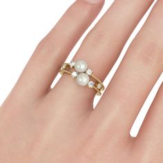 Delicate and exquisite, this ring makes a little lovely gift for loved one or yourself. Crafted in gold tone sterling silver, set with two faux pearls and adorned with delicate milgrain detailing. the ring will show a really beautiful look on your finger. treat yourself or surprise her with this dainty piece.Carat Weight: 3 ctStone Size: 6 mmStone Type: Jeulia® StoneNumber of Stones: 2 Stone Color: Diamond WhiteStone Shape: RoundCarat Weight: 0.521 ctStone Size: 2.4,2.1 mmStone Type: Jeulia® Sto Jeulia Jewelry, Pearl Engagement Ring, Engagement Rings For Women, White Sapphire Ring, Women's Rings, Split Shank, Jewelry Outfit, Ring Fit, Perfect Engagement Ring