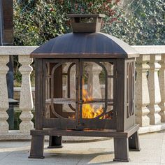 an outdoor fire pit sitting on top of a sidewalk