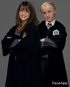 two young children dressed in harry potter costumes posing for a photo with their arms crossed