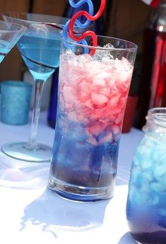 two glasses filled with blue and red liquid