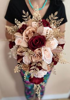 Glamourous and Elegant real touch rose goldburgundy and blush Wedding Bouquet made with the most realistic silk flowersRoses symbolize love and romance which makes this one of kind bouquet perfect for the celebration of your weddingThis gorgeous bouquet is loaded with Burgundy Rose Gold and Blush Roses and gold LeavesWe can add different colors if you'd like toThe Cascading Bridal size shown 16Long bouquet9Wide for Maid of honor and 7is for bridesmaid bouquet and we can do Maroon And Gold Bouquet, Fall Rose Gold Wedding, Burgundy And Gold Flowers, Black Rose Gold Maroon Wedding, Blush Burgundy Gold Wedding, Rose Gold And Red Wedding Theme, Burgundy Pink Wedding Cake, Black Burgundy And Pink Wedding, Gold And Maroon Wedding Theme