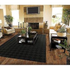 a living room filled with furniture and a flat screen tv mounted on the wall above a fireplace