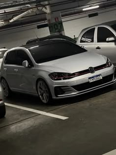 three cars parked in a parking garage next to each other