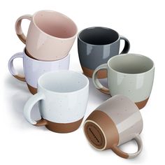 four different colored coffee mugs sitting next to each other