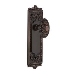 an antique style door handle with ornate designs on the front and side panels, in dark bronze