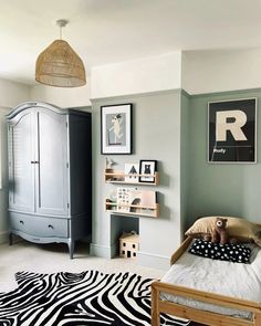 a bedroom with zebra print rug and green walls