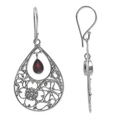 This pair of delicate earrings with a garnet garnish creates an eloquent statement. Made Sudiari designs this pair of dangle earrings from sterling silver with openwork floral motifs. Teardrop-shaped garnet stones totaling two carats hang within the earrings for a noble look. Sterling Silver& Garnet Hook earrings Combination finish Handmade in & fairly traded from Indonesia Due to the handmade nature of this product, exact color and pattern of stone may vary.