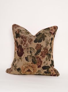 a floral pillow on a white background