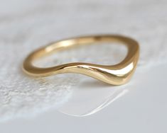 This is a Unique Wedding Band, Gold Wedding Band, Women Wedding Band, Boho Wedding Band, Gold Wave Ring, a beautiful Curved Wedding Band, Modern Wedding Ring. A beautifully handmade gold ring, designed to be timeless and worn forever. This gold ring is uniquely asymmetrical, which makes it look different from every angle you look at. B O H O ∙ W E D D I N G ∙ B A N D ✧ Measurements: ✦ The ring width is approx 3.5 mm at the top and 2.5 mm at the bottom. The ring is about 3 mm thick at the top (he Curved Gold Wedding Band, Wavy Wedding Band, Boho Wedding Band, Organic Wedding Band, Boho Wedding Bands, Wave Wedding Band, Modern Wedding Ring, Gold Wedding Band Women, Modern Wedding Rings