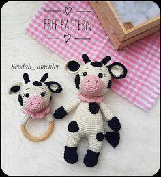 two crocheted stuffed animals sitting next to each other on a white surface with pink and black checkered tablecloth