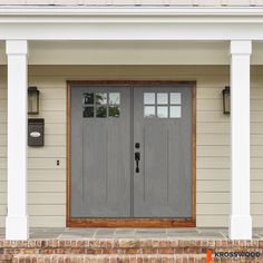 the front door of a house with two lights on each side