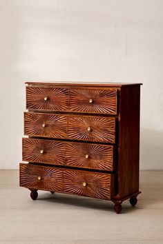 a wooden dresser with four drawers on wheels