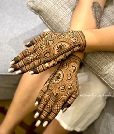 a woman's hands with hennap on it, showing the intricate design