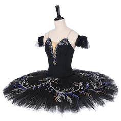 a black tutu dress with blue and silver flowers on it, sitting on a mannequin