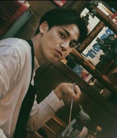 a young man eating food from a bowl