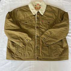 Levi’s Type 3 Canvas Sherpa Jean Jacket In Dark Khaki Size Xxl. New With Tags! Snap Front Closure, Snap Flap Chest Pockets, Front Welt Pockets, Snap Cuffs, Snap Adjustable Back Tabs, Dark Khaki With Cream Colored Sherpa, Inside Chest Pocket Measurements Laying Flat-Pit To Pit=29”, Sleeve Length Shoulder Seam To Cuff=26”, Shoulder To Shoulder Seams Across The Back=22”, Length From Bottom Of Back Collar Seam To Hem=27.5” Levi's Brown Outerwear With Pockets, Levi's Khaki Outerwear With Pockets, Winter Khaki Outerwear With Corduroy Collar, Levi's Casual Khaki Outerwear, Levi's Khaki Casual Outerwear, Levi's Brown Winter Outerwear, Levi's Long Sleeve Outdoor Outerwear, Brown Sherpa Outerwear With Pockets, Levi's Cold Weather Outerwear With Pockets