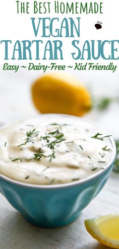 the best homemade vegan tartar sauce in a blue bowl with lemon wedges