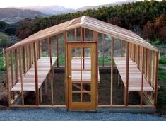 a small wooden structure sitting on top of a gravel field