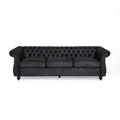 a black leather couch with buttons on the back and arms, sitting in front of a white background