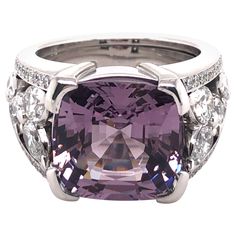 This extraordinary ring in 18 karat white gold is set with a beautiful cushion-shaped violet Burmese spinel of 8.90 carats. The handcrafted mounting is signed Peclard and is set with 12 pear-shaped diamonds and 44 brilliant-cut diamonds of F/G colour and vs clarity with a total weight of approximately 2.41 ct. The violet spinel is accompanied by Gübelin Gem Lab Report No. 15070050. Maker's mark on mounting: PECLARD Assay mark: 750 Ring size: 52 (EU) / 6 (US) Width: 5.50 - 12.00 mm / 0.21 - 0.47 Spinel Jewelry, Lab Report, Pear Shaped Diamond, Burmese, Brilliant Cut Diamond, Cocktail Rings, Makers Mark, Pear Shaped, Diamond Ring