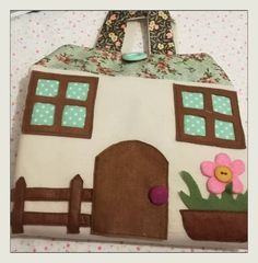 a cake shaped like a house with flowers on the outside and a door in the middle