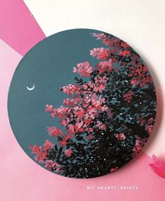 a pink and blue painting with flowers in the foreground on a circular surface that says my hearty paintings