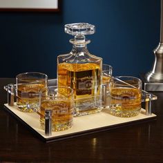 an assortment of whiskeys and glasses on a tray